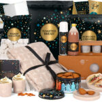 Kerstpakket Make a Wish met luxe snacks, chocolademelk, koekjes, chips, plaid en feestelijke verpakking.